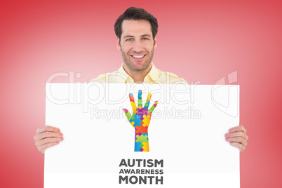 Composite image of attractive man smiling and holding poster