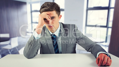 Composite image of serious businessman