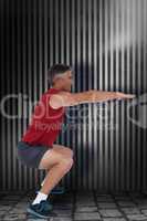 Composite image of fit man doing a squat