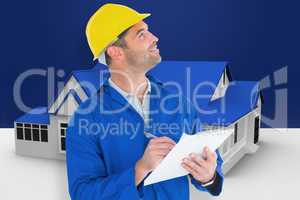 Composite image of male supervisor looking up while writing on c