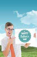 Composite image of geeky hipster smiling and showing card