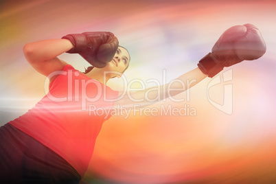 Composite image of fit woman boxing