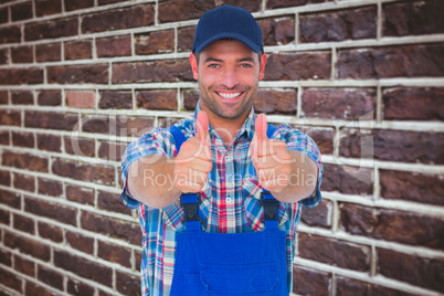 Composite image of portrait of happy male repairman gesturing th