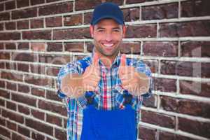 Composite image of portrait of happy male repairman gesturing th