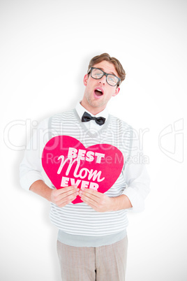 Composite image of geeky hipster holding heart card