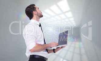 Composite image of sophisticated businessman standing using a la