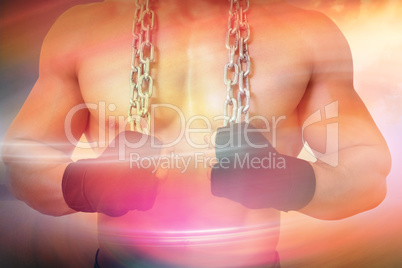 Composite image of mid section of a shirtless muscular man holdi