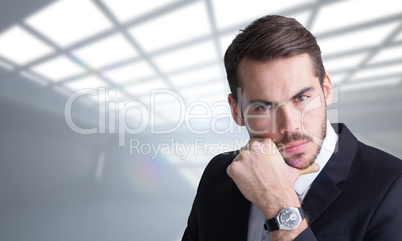 Composite image of cheerful businessman posing with hand on chin