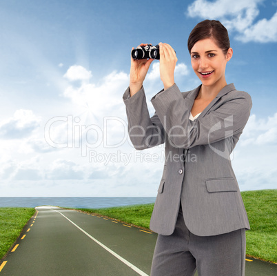 Composite image of businesswoman posing with binoculars