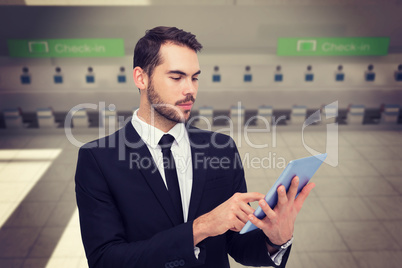 Composite image of cheerful businessman touching digital tablet