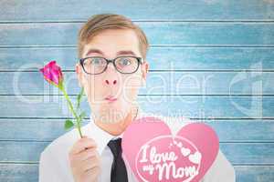 Composite image of geeky hipster holding a red rose and heart ca