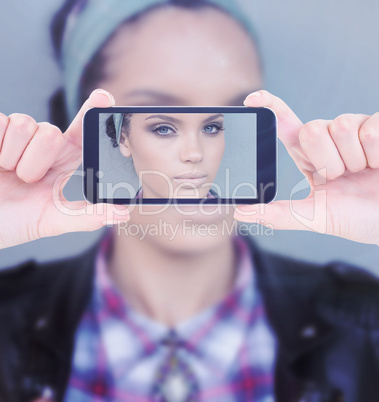 Composite image of hands holding smartphone