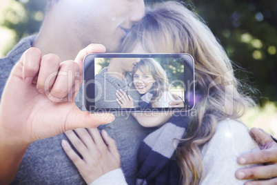 Composite image of hand holding smartphone showing