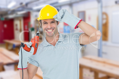 Composite image of handsome architect holding drill machine