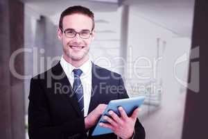 Composite image of happy businessman using his tablet pc