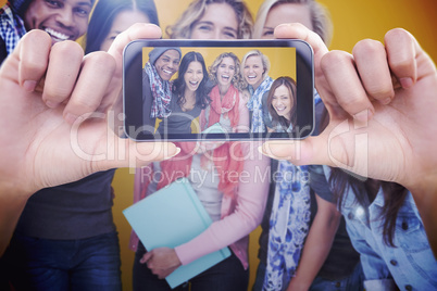 Composite image of hand holding smartphone showing