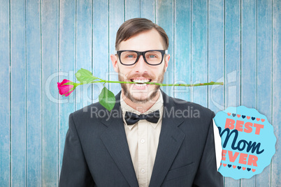 Composite image of geeky hipster holding rose between teeth