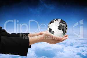 Composite image of businesswomans hands presenting