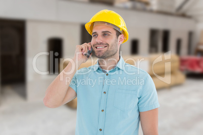 Composite image of happy male architect conversing on mobile pho