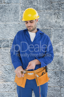 Composite image of male electrician cutting wires