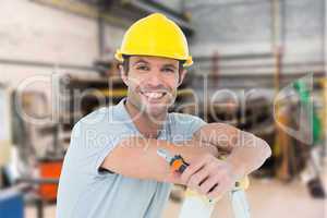 Composite image of technician holding pliers while leaning on la