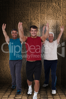 Composite image of fit men stretching their arms