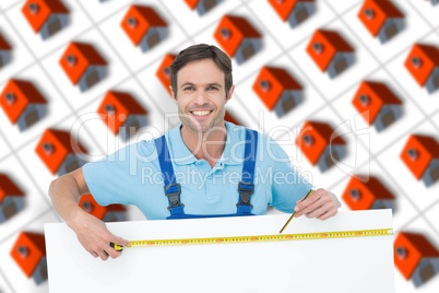 Composite image of happy carpenter measuring blank bill board