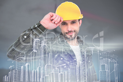 Composite image of smiling handyman holding helmet