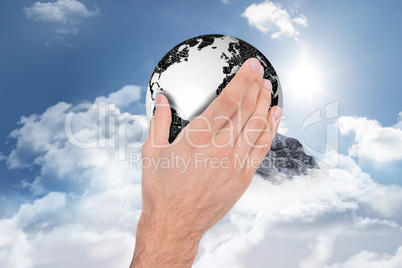 Composite image of businessman holding hand out in presentation