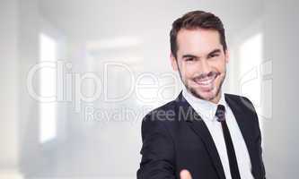 Composite image of portrait of smiling businessman offering hand