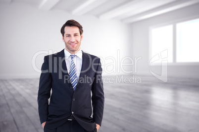 Composite image of smiling businessman standing with hands in po