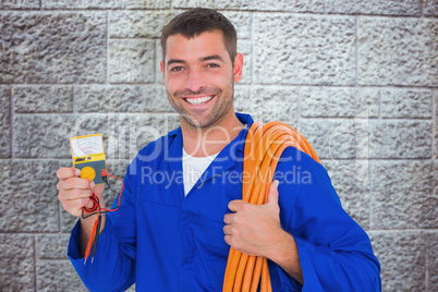 Composite image of smiling electrician with rolled wire and mult