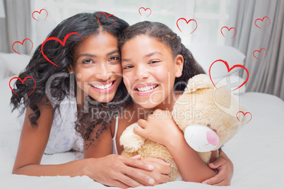 Composite image of pretty woman lying on bed with her daughter s