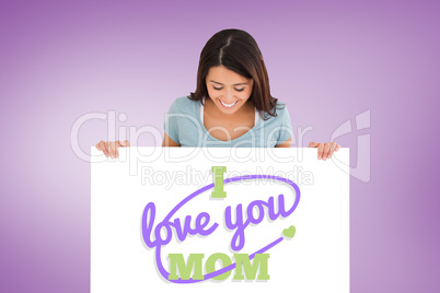 Composite image of good looking woman holding a  board