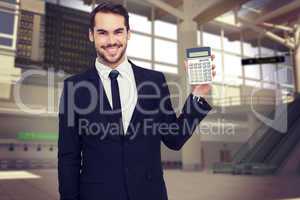 Composite image of smiling businessman presenting a calculator