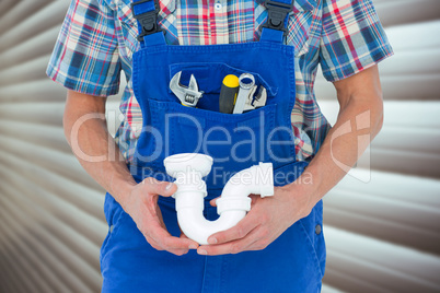 Composite image of cropped image of plumber holding sink pipe