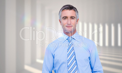 Composite image of smiling businessman in suit with hands in poc