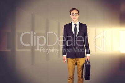 Composite image of young geeky businessman holding briefcase