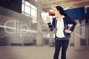 Composite image of pretty businesswoman shouting with megaphone