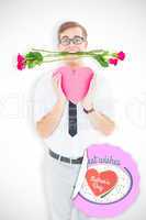 Composite image of geeky hipster holding red roses and heart car