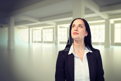 Composite image of pretty businesswoman looking up