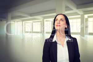 Composite image of pretty businesswoman looking up