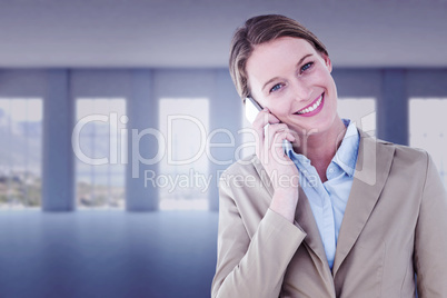 Composite image of businesswoman using her mobile phone