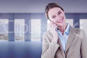 Composite image of businesswoman using her mobile phone