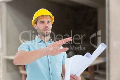 Composite image of architect with blueprint gesturing on white b