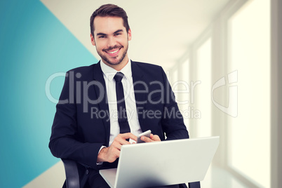 Composite image of happy businessman with laptop using smartphon