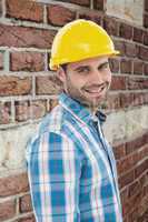 Composite image of confident repairman wearing hard hat