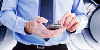 Composite image of close up of a businessman using a smartphone