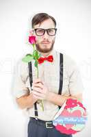 Composite image of geeky hipster offering a rose