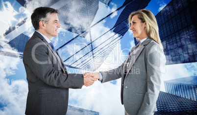 Composite image of pleased businessman shaking the hand of conte